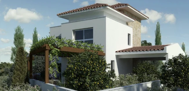 Modern two-story house with white walls, red-tiled roof, and large windows. A wooden pergola covered in greenery stands in front, surrounded by lush bushes and trees under a blue sky with scattered clouds.